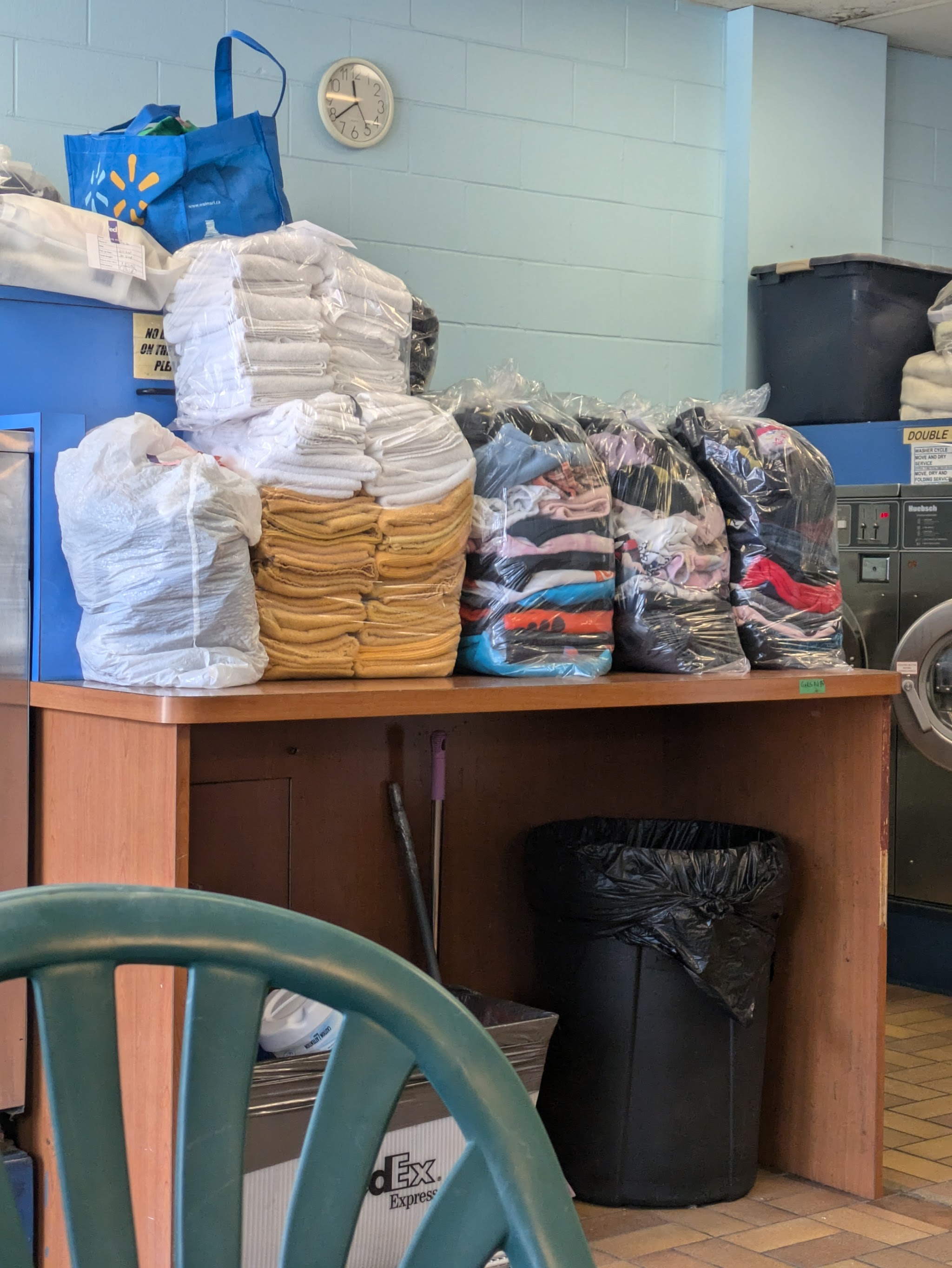 Neatly stacked drop-off laundry ready for pickup