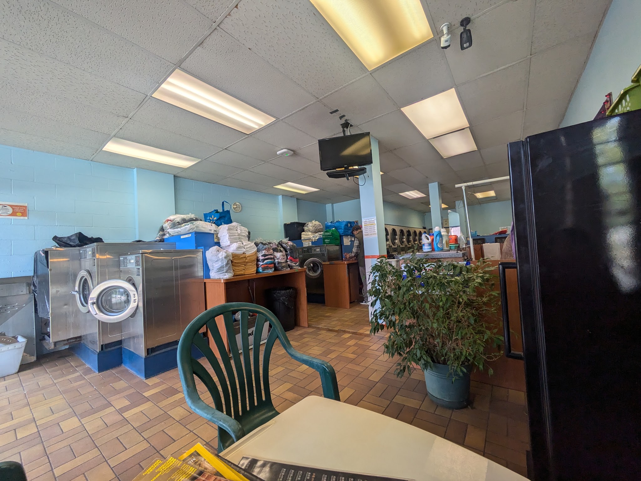 Interior view with blue walls, machines, and seating area